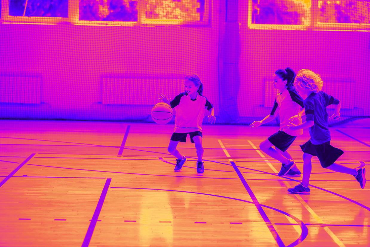 Children playing together in a school gym